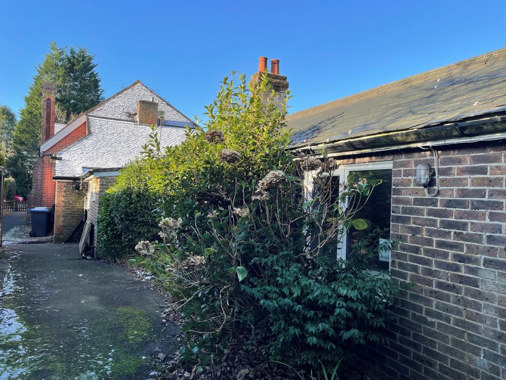 Lot: 134 - FORMER VILLAGE HALL WITH CONSENT FOR CONVERSION INTO SIX RESIDENTIAL DWELLINGS - Rear view from outside area